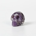 Polished amethyst skull figurine with natural white veining on a white background - 1.5 Inch / Amethyst