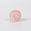 Polished natural rose quartz skull carving with detailed facial features and pink hue - 1.5 Inch / Rose Quartz