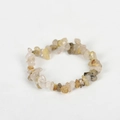 Handmade bracelet with irregular natural yellow crystal stones on a plain background - Rutilated Quartz