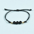 Minimalist black rope bracelet with three polished black beads and gold accents - Obsidian