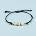 Bracciale in corda nera fatto a mano con tre pietre naturali blu e venature marroni - Diaspro Pelle di Serpente