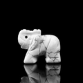 Hand-carved 1.5-inch white turquoise elephant figurine with natural stone texture on black background - Howlite (Small)
