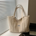 Large beige corduroy tote bag with 'Fashion Instinct' label and front pocket feature - Khaki