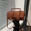 Brown handbag with floral embossing and gold twist locks and adjustable strap - Brown