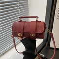Retro burgundy cylindrical crossbody bag with floral embossing and gold metal locks - Red