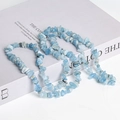 Sky blue irregular crushed crystal beads for DIY jewelry making on white book - Aquamarine