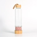 Bamboo glass water bottle with pink crystal stones and brown braided carrying strap - Rose Quartz