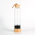 Bamboo lid glass water bottle featuring natural black obsidian crystals in a separate base - Obsidian