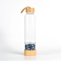 Eco-friendly glass water bottle with bamboo lid and base filled with blue natural stones - Lapis Lazuli