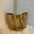 Large khaki leather tote bag with fashion logo on white shutter background for women - Tan