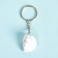 Minimalist white turquoise key ring with natural irregular stone on blue background - Howlite