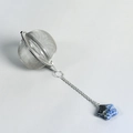 Mesh stainless steel tea infuser ball featuring a blue marble star pendant detail - Blue Spot Jasper