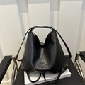 Large black leather tote bag with logo on white book, minimalist commuter style 2024 - Black