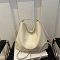 Minimalist beige PU leather large tote bag on a chair with natural soft texture - White
