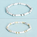 White howlite beaded bracelets set with gold and silver spacer beads on blue background - White Turquoise - Gold Spacers