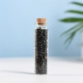 Polished black obsidian gemstone chips in a transparent glass bottle with cork stopper - Obsidian (5-7mm)