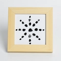 Minimalist wooden frame featuring a sunburst pattern of polished black stone crystals - Obsidian