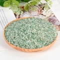 Natural green aventurine crystal stones displayed in a round wooden tray for aromatherapy - Green Aventurine / 3-5mm / 300g