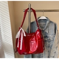 Detail of red patent leather tote bag with white lace bow and embossed number 10 - Burgundy