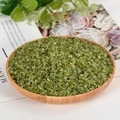 Natural peridot crystal chips displayed in a round wooden tray for home decor - Peridot / 3-5mm / 300g