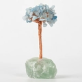 Handmade crystal tree with light blue stones, copper wire, and a green raw stone base - Green Fluorite Base Aquamarine Leaves