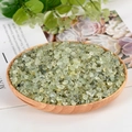 Natural prehnite crystal chips in light green finish presented in a wooden bowl - Prehnite / 5-7mm / 300g