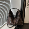 Leopard print tote bag with metal zippers and bow detail in a stylish sunlit setting - Brown