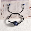 Adjustable woven rope bracelet featuring a raw dark blue lapis lazuli crystal stone - Blue Sodalite