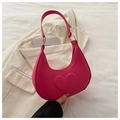Detail of rose pink crescent bag featuring a 3D heart pattern and gold metal hardware - Rose Pink