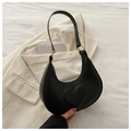 Detail of a black crescent shoulder bag with a unique embossed 3D heart pattern and gold rings - Black