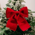 Red velvet Christmas bow ornament with gold trim on a festive holiday tree branch - Wine Red Hemmed Sponge Bow