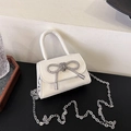 Mini white crossbody bag with silver rhinestone bow and chain strap for women - White