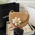 Handcrafted straw saddle bag with a white daisy floral accent and thin woven shoulder strap - Khaki