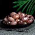 Polished natural strawberry quartz healing stones displayed in a black decorative tray - Strawberry Quartz 2-3cm 100g