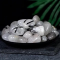 Polished black rutilated quartz tumble stones displayed on a black zen stone plate - White-bodied Black Tourmaline 2-3cm 100g