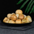 Polished natural yellow crystal tumbled stones in a black tray for home decor - Huang Dongling 2-3cm 100g