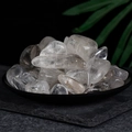 Polished natural clear quartz tumbled stones in a black dish for home decor and healing - Light Brown Polished To A Natural Shape 3-5cm.