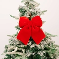 Velvet Christmas bow ornament in vibrant red hanging on a snowy holiday tree - Medium / Red