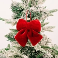 Christmas tree ornament featuring a red velvet bow hanging on a snowy pine branch - Small / Burgundy