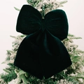 Dark green velvet bow ornament with soft texture hanging on a snowy Christmas tree branch - Large / Green