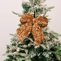 Sparkling dark gold sequin Christmas bow pendant hanging on a snow-flocked tree branch - Small Yellow