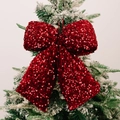 Sparkling red sequin Christmas bow pendant hanging on a snow-dusted green tree branch - Large Size Red