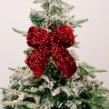 Sparkling red sequin Christmas bow ornament hanging on a snowy Christmas tree branch - Small Red