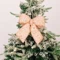 Sparkling champagne gold sequin bow ornament hanging on a Christmas tree branch - Small Champagne