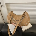Khaki crocodile pattern crescent bag with silver chain and rivets held by hand - Khaki