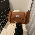 Caramel brown pebbled leather shoulder bag with silver twist lock and crescent shape - Brown