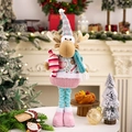 Pink Christmas reindeer doll with telescopic legs in cozy fireplace home decor setting - Pink and Blue Series Telescopic Christmas Reindeer Doll