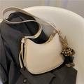 Cream white crescent saddle bag with cute bunny pendant on modern grey blazer background - Off White