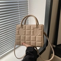 Quilted cream crossbody bag with round top handles and minimalist grid design for women - Khaki