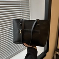 Classic black tote bag with gold zipper pocket and slim shoulder straps for daily commute - Black
